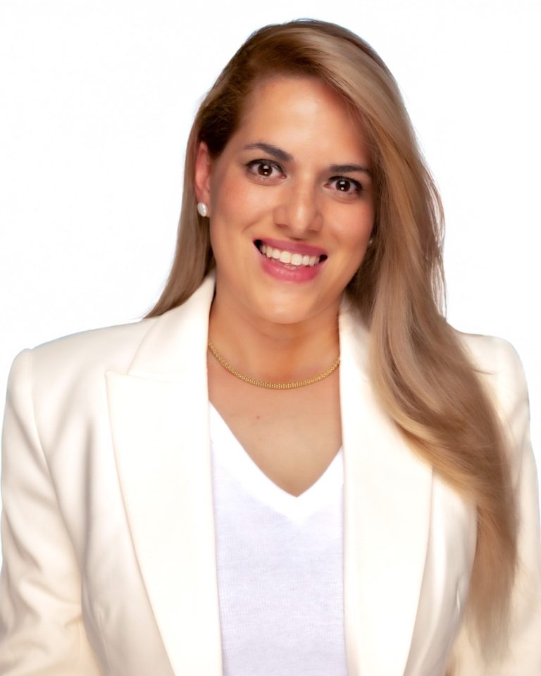 Honduran candidate Milagros Gonzalez posing for her headshot at Headshot Studio Portraits, wearing a white blazer and white top.